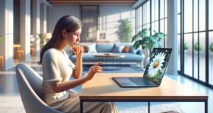 Una mujer joven sentada en una mesa en una habitación moderna, adivinando el futuro en línea usando una margarita en su computadora portátil.