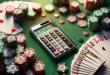 Image of a poker calculator with probability display surrounded by cards and poker chips on a green cloth.